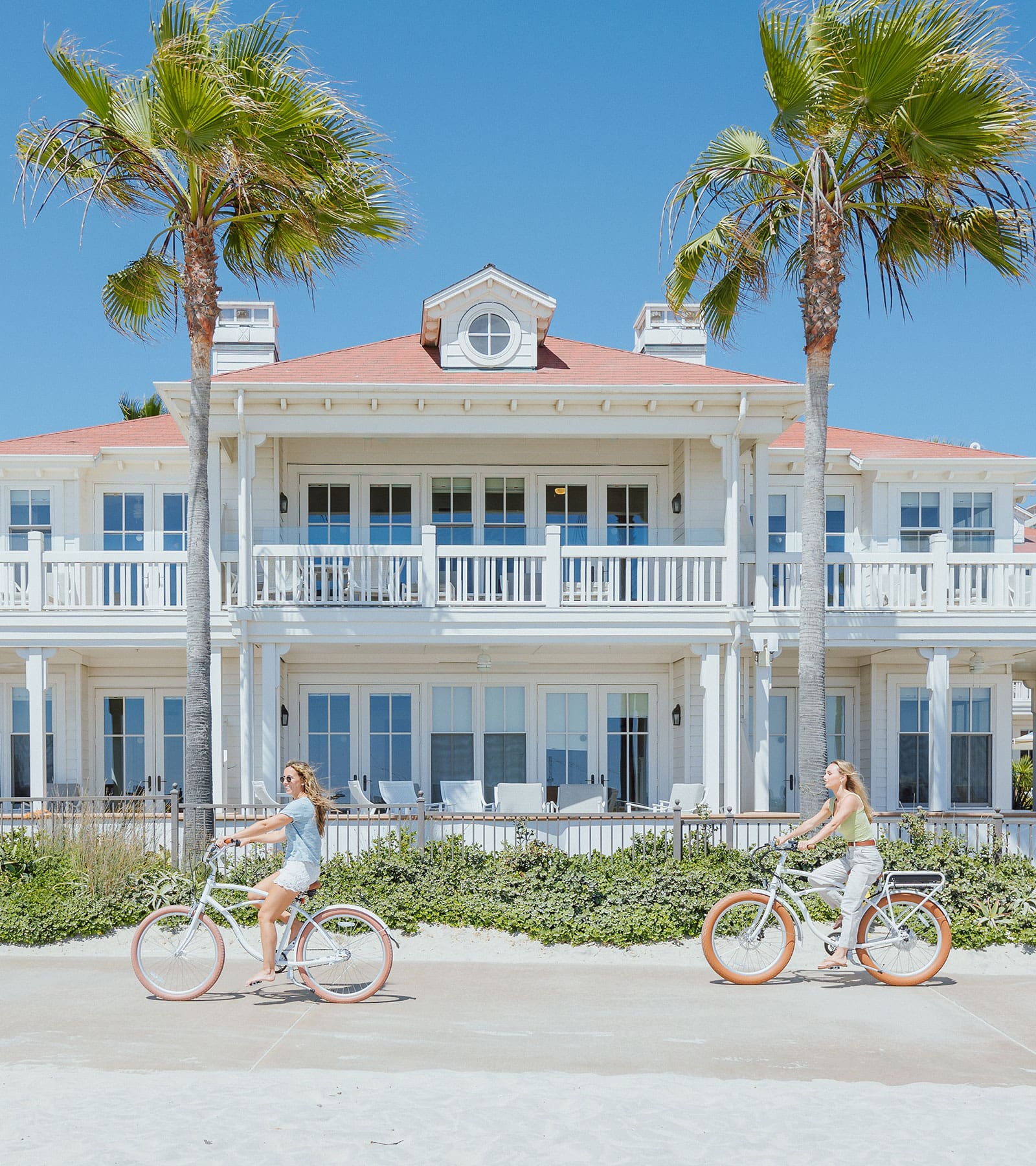 Woman riding bikes along the beach