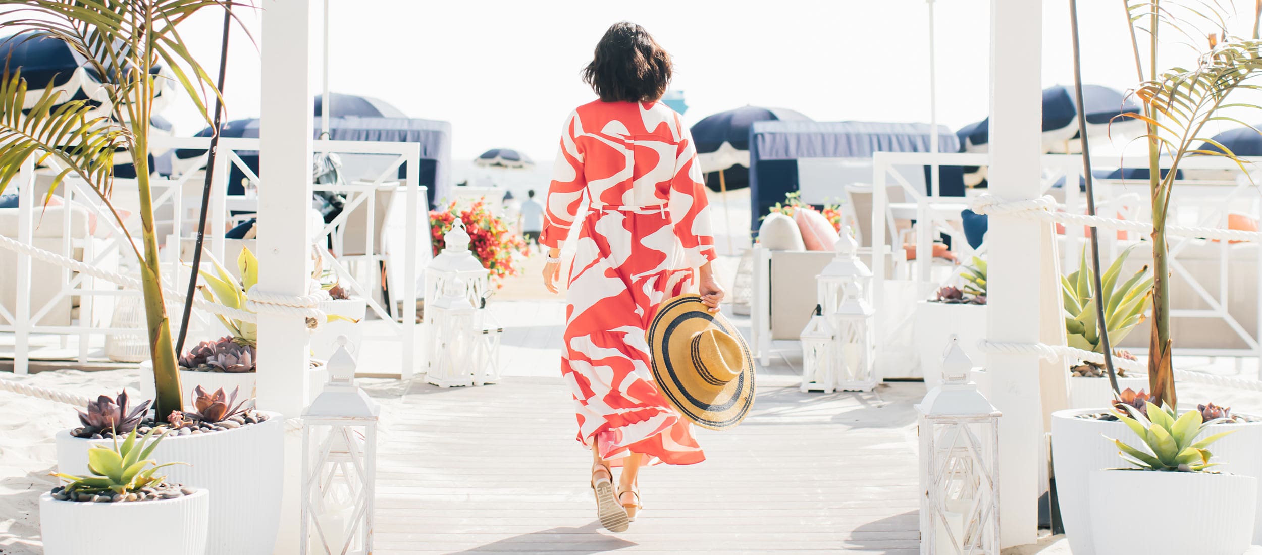 Woman walking into The Beach Club