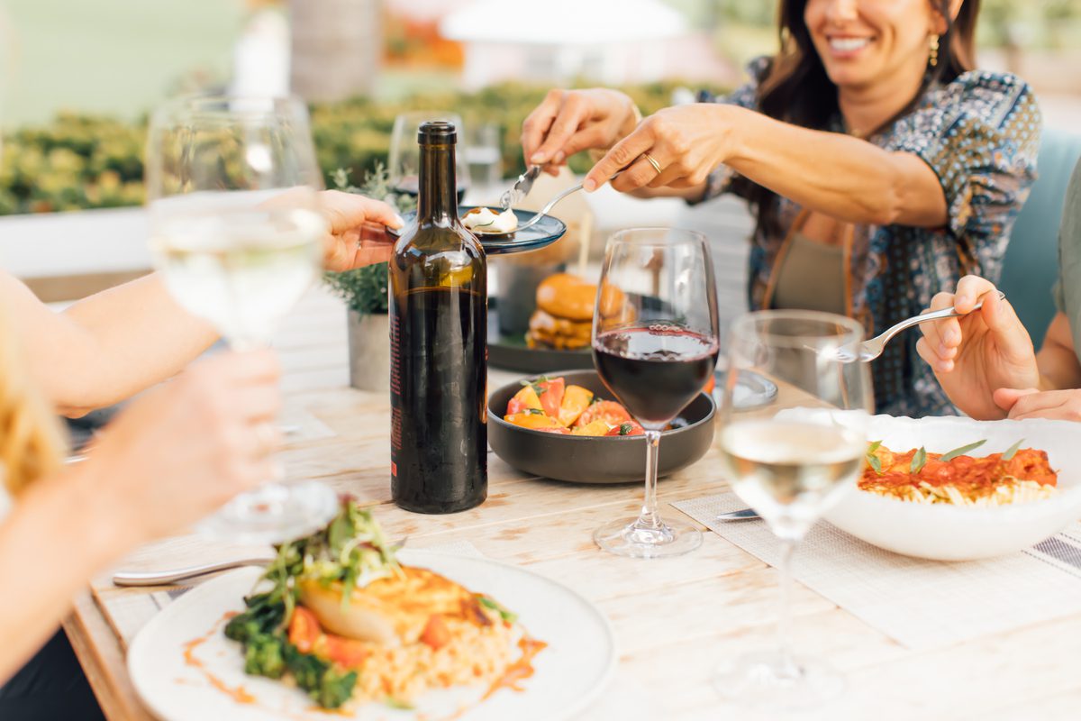 Table of food and wine with friends sharing
