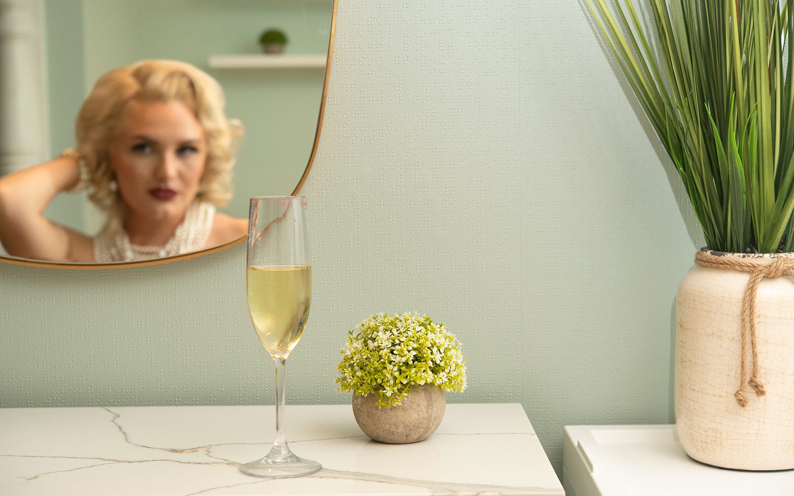 Blonde woman in mirror with champagne