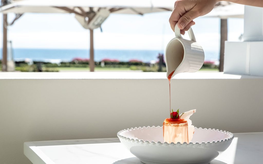 Chilled vanilla souffle with a strawberry rosewater elixir poured onto it