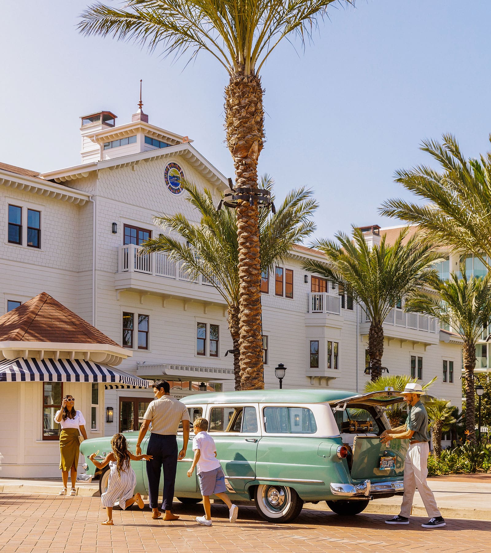 Family with vintage car on driveway